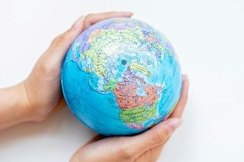 Two hands holding a globe
