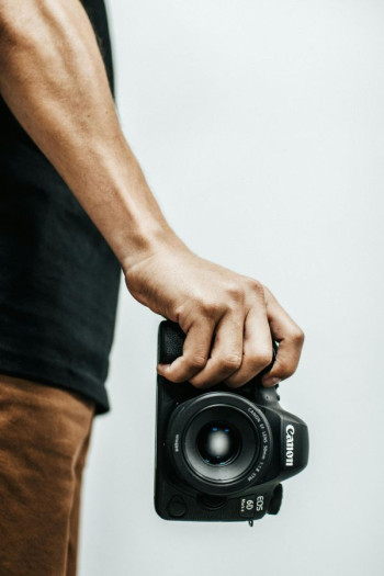 Person holding Canon Dslr camera