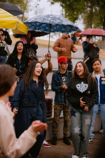 A group of people stand around at an event