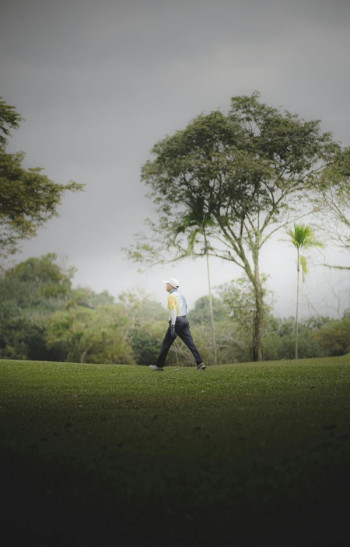 A man walks on a golf course