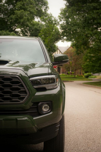 A green car parked up in the suburbs