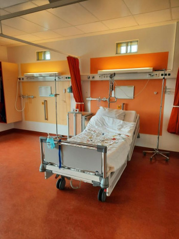 A hospital bed sits empty