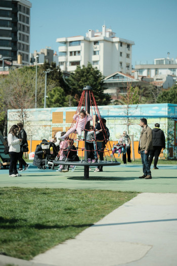 Children play on a playground in a city.