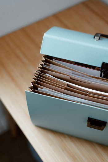 An open filing box sits on a table.